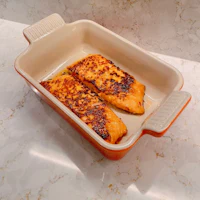 two salmon fillets in a baking dish