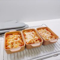 three lasagna dishes on a rack