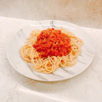 a plate of spaghetti with sauce on it