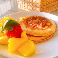 a plate of pancakes and fruit on a table