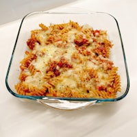 a glass baking dish with pasta in it