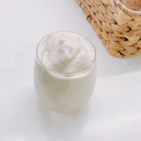 a glass of yogurt with a basket next to it