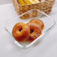 two bagels in a basket on a white table