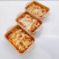 three lasagna dishes are sitting on a table