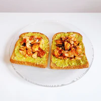 two pieces of toast with guacamole on them