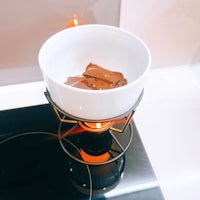 a bowl of chocolate sitting on top of a stove