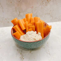 carrot sticks in a bowl with dip